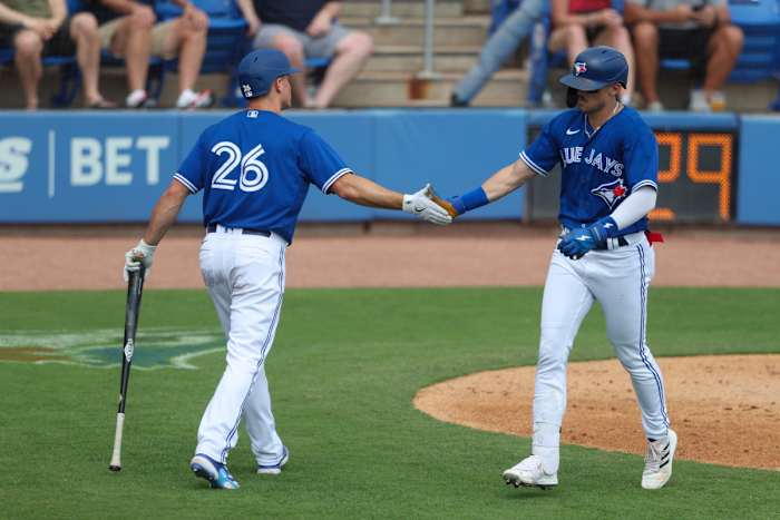 Mar 9, 2023; Dunedin, Florida, USA; Toronto Blue Jays second baseman Cavan Biggio (8) is congratulated by third baseman Matt Chapman (26) after hitting a solo home run against the Atlanta Braves in the third inning at Amalie Arena. Mandatory Credit: Nathan Ray Seebeck-USA TODAY Sports